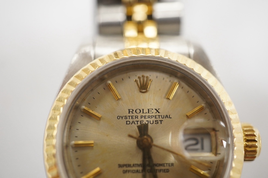 A lady's late 1980's steel and gold Rolex Oyster Perpetual Datejust wrist watch, with baton numerals, serial no. 9773085, on a steel and gold Rolex bracelet, no box or papers. Condition - poor to fair